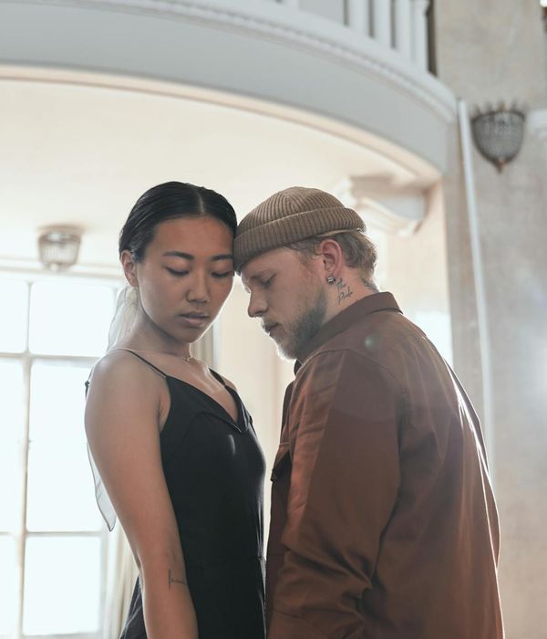 Woman performing a fluid, gentle movement in a bright, peaceful room.